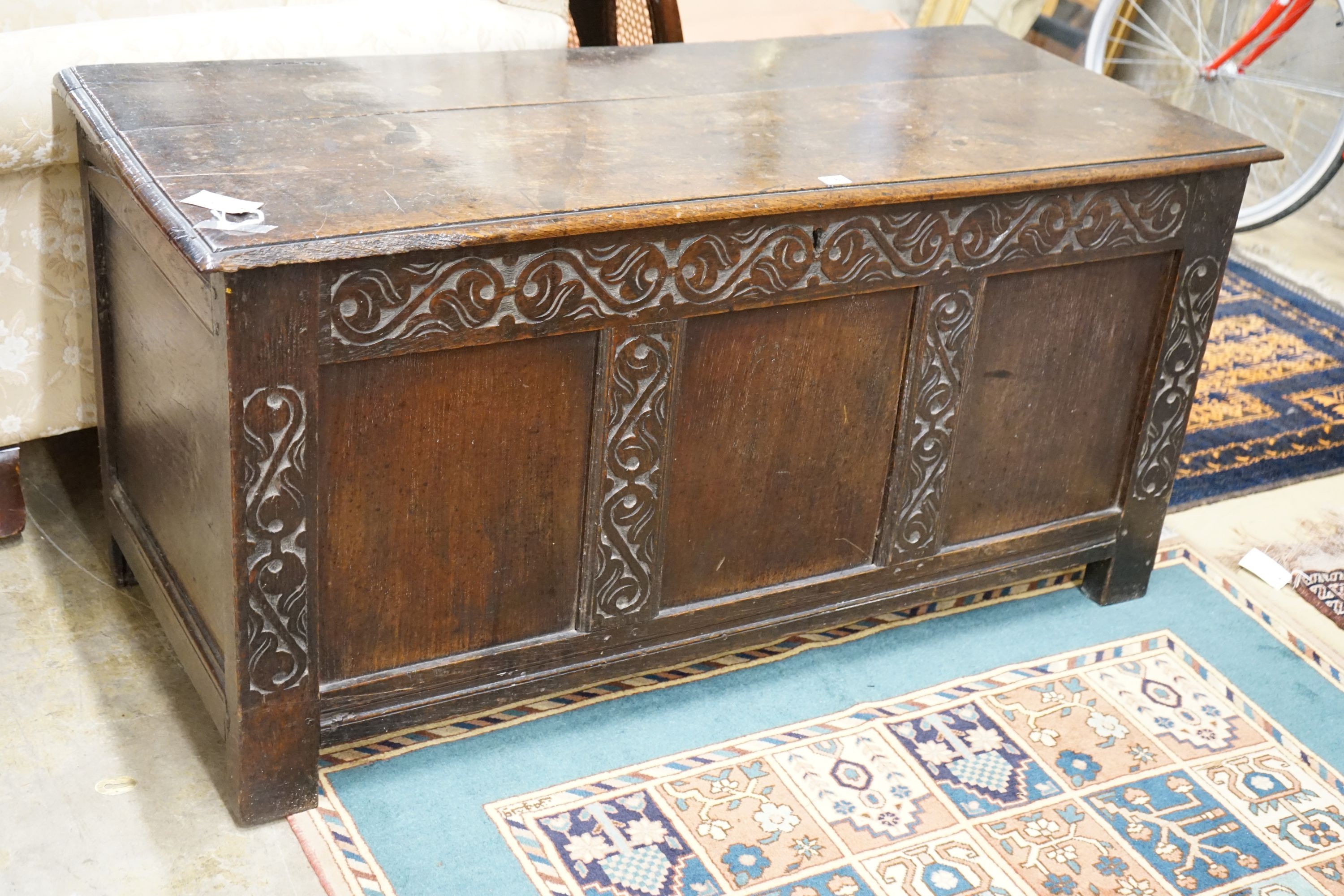 A late 17th / early 18th century carved and panelled oak coffer, length 136cm, depth 58cm, height 66cm